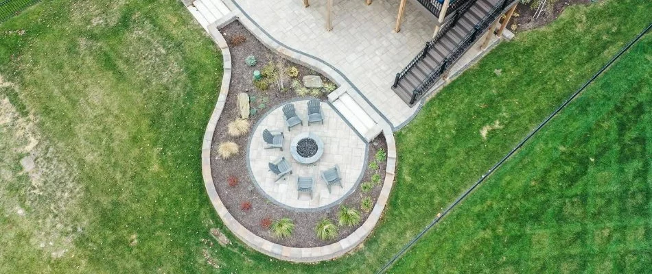 Landscape around a patio in Shawnee, KS, with a fire pit.