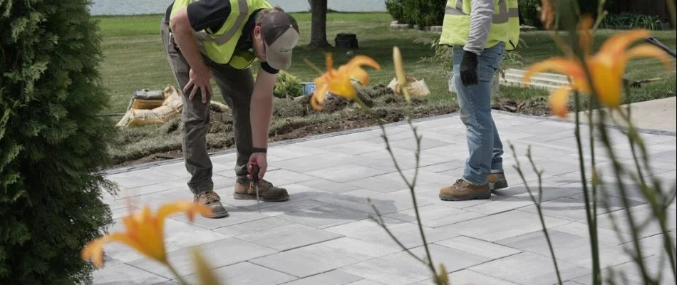 Workers on a paver patio in Olathe, KS.