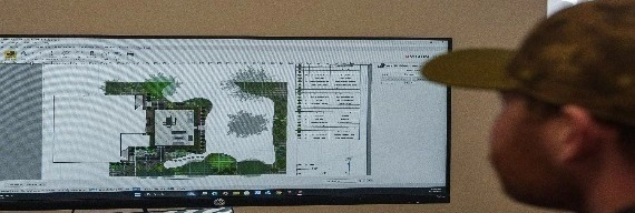 Designer creating landscape plan in Olathe, KS.